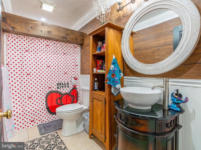 bathroom featuring vanity, wood walls, tile patterned flooring, toilet, and ornamental molding