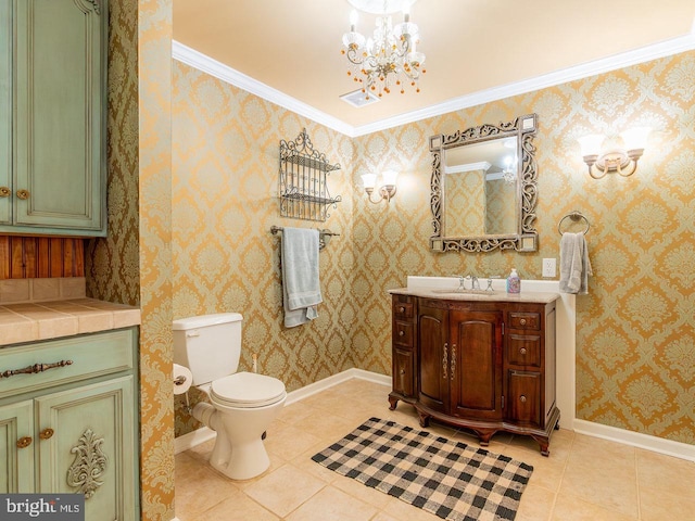 bathroom with vanity, an inviting chandelier, tile patterned floors, and ornamental molding