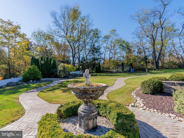 view of property's community with a lawn