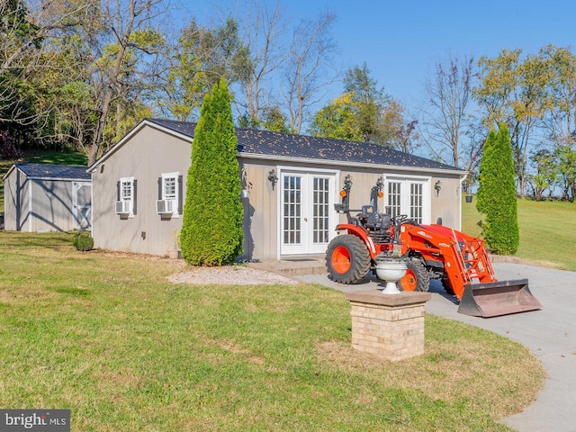 rear view of house with a lawn and french doors