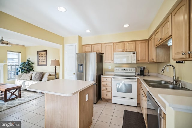 kitchen featuring sink, ceiling fan, appliances with stainless steel finishes, a kitchen island, and light tile patterned flooring