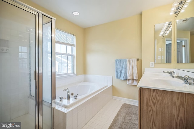 bathroom featuring vanity, independent shower and bath, and tile patterned flooring