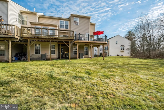 back of house featuring central AC, a deck, and a lawn