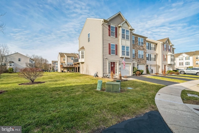 multi unit property featuring a garage and a front lawn