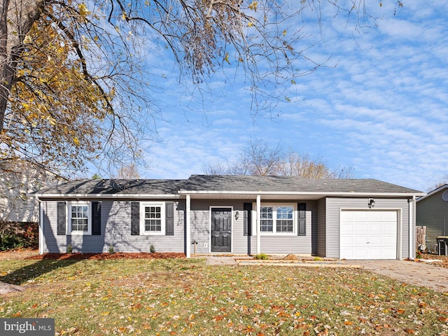 ranch-style home featuring a garage and a front lawn