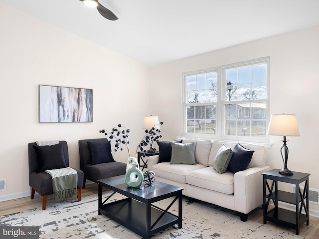 living room featuring light hardwood / wood-style flooring and ceiling fan