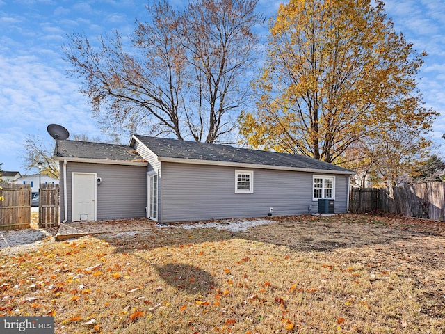 view of home's exterior with cooling unit and a yard