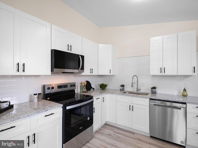 kitchen with white cabinetry and appliances with stainless steel finishes