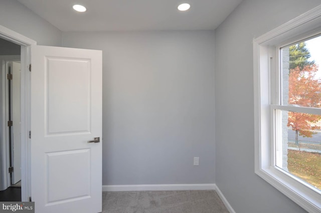 carpeted empty room featuring plenty of natural light