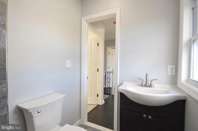 bathroom with vanity, wood-type flooring, and toilet