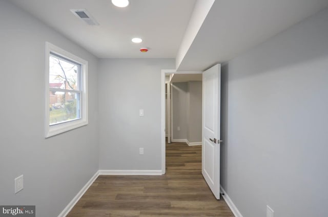 corridor with dark hardwood / wood-style floors