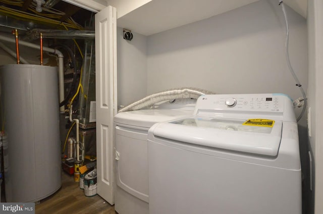 laundry room featuring independent washer and dryer, gas water heater, and dark hardwood / wood-style floors