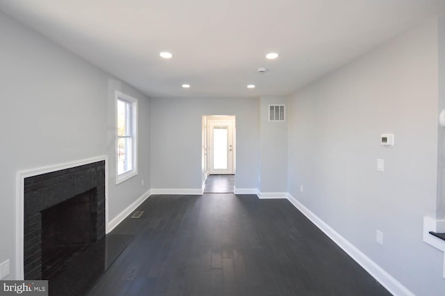 unfurnished living room featuring dark wood-type flooring