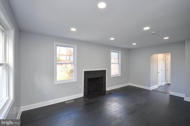 unfurnished living room featuring dark wood-type flooring