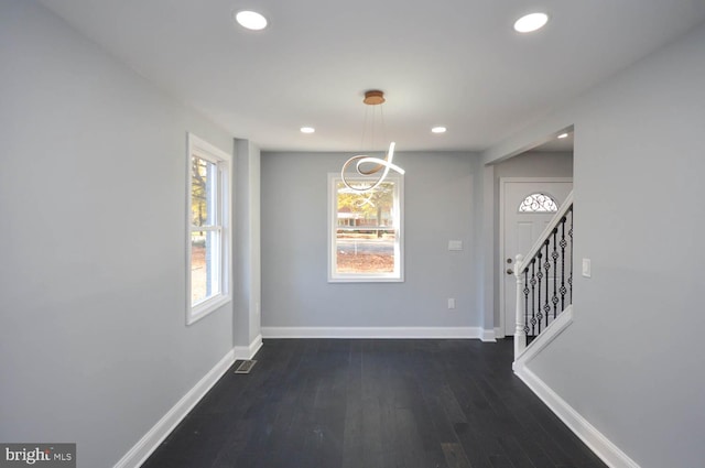 unfurnished dining area with dark hardwood / wood-style flooring