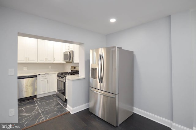 kitchen featuring white cabinets, dark wood-type flooring, and appliances with stainless steel finishes