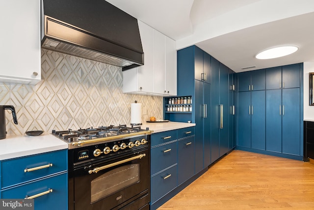 2510 Virginia Ave NW Unit 1104-N, Washington, DC 20037 - kitchen featuring premium range hood, gas stove, blue cabinets, and light countertops