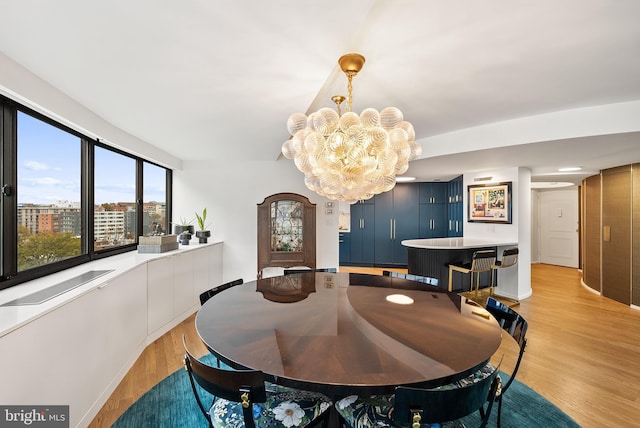 2510 Virginia Ave NW Unit 1104-N, Washington, DC 20037 - dining space with light wood finished floors and a chandelier
