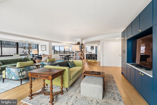 living room featuring light hardwood / wood-style floors and a notable chandelier