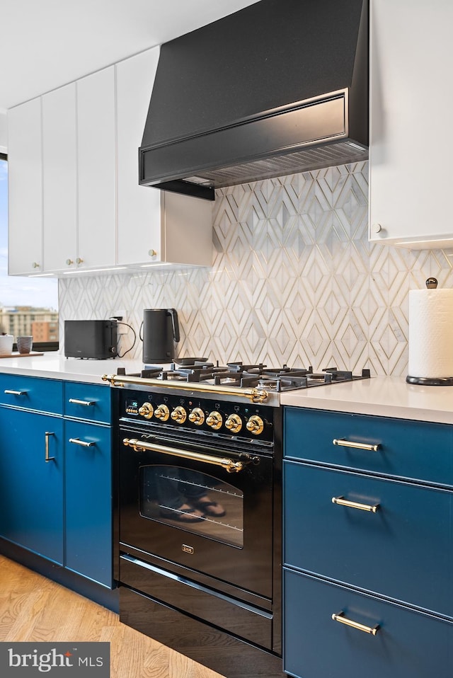 2510 Virginia Ave NW Unit 1104-N, Washington, DC 20037 - kitchen featuring range hood, blue cabinets, black gas stove, and light countertops
