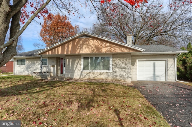 ranch-style home with a garage and a front lawn