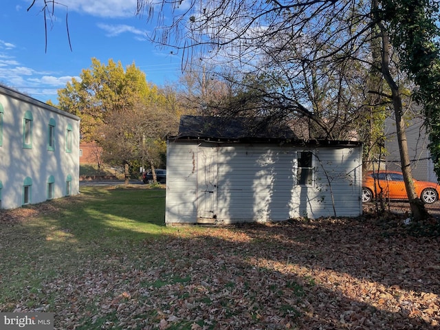 view of outdoor structure featuring a lawn