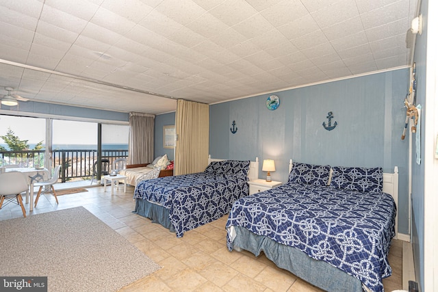 bedroom featuring a water view and access to outside