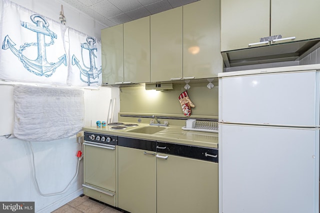 kitchen featuring sink, light tile patterned flooring, and white refrigerator