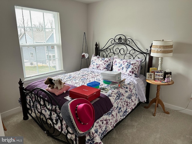 carpeted bedroom with multiple windows