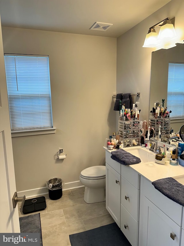 bathroom with tile patterned flooring, vanity, and toilet