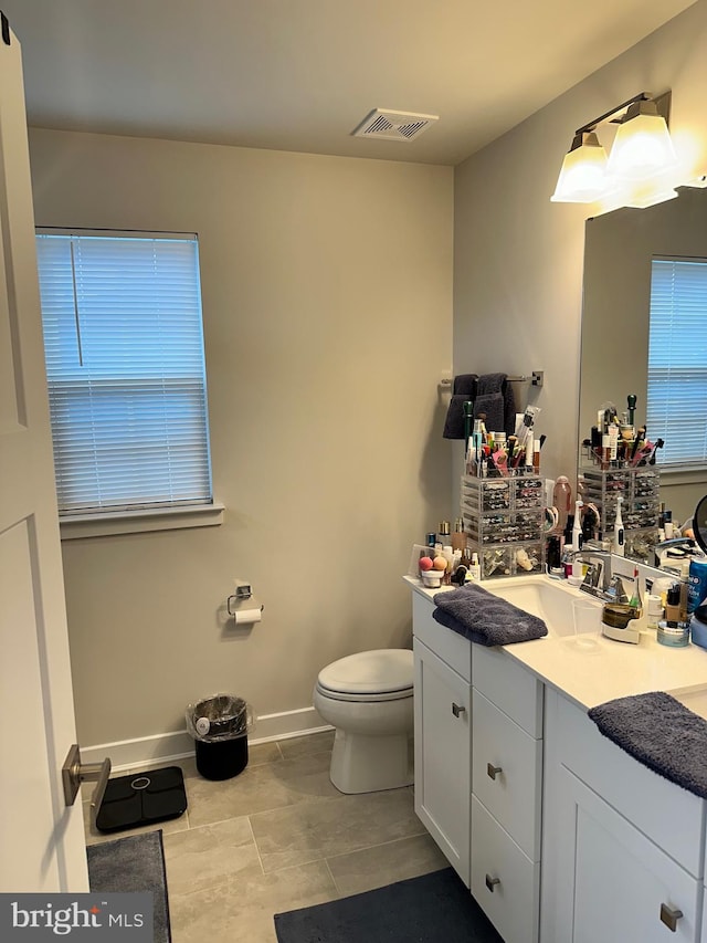 bathroom with tile patterned floors, vanity, and toilet