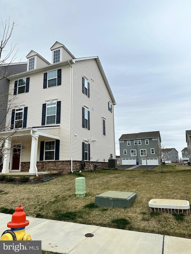 view of home's exterior featuring a yard and cooling unit