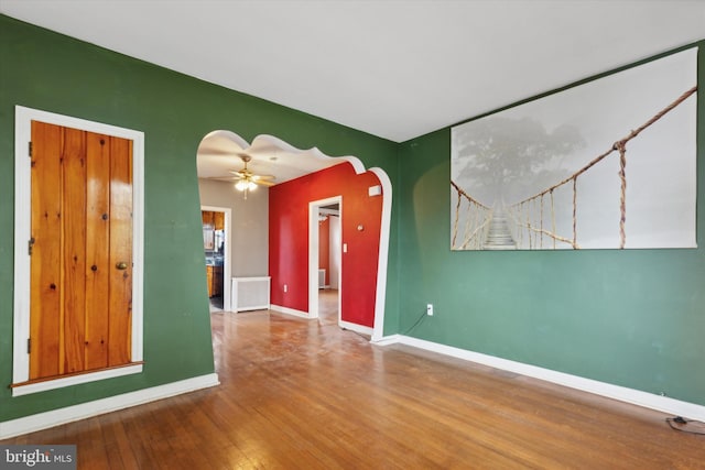 spare room with ceiling fan and hardwood / wood-style flooring