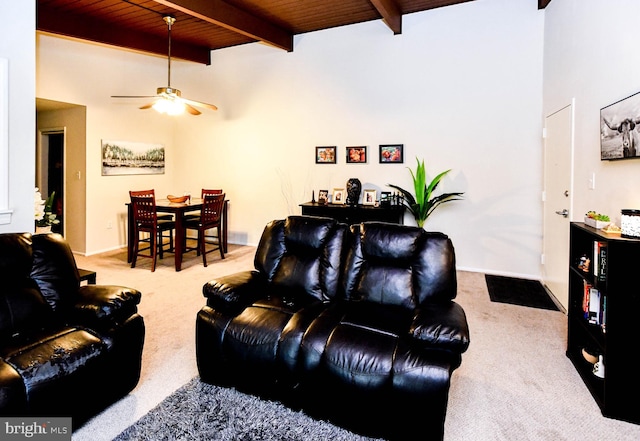 living room with ceiling fan, beam ceiling, wooden ceiling, and light carpet