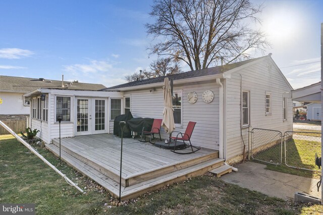 rear view of property featuring french doors, fence, a wooden deck, and a gate