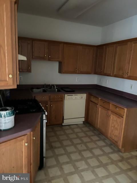 kitchen featuring dishwasher, sink, black range with gas cooktop, and exhaust hood