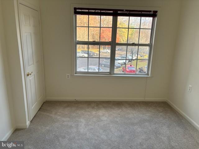 spare room with light colored carpet