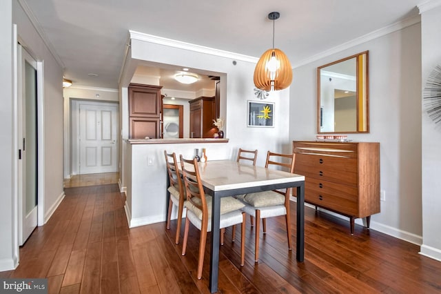 dining space with dark wood-type flooring and ornamental molding