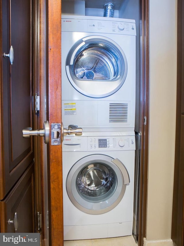 laundry room with stacked washing maching and dryer