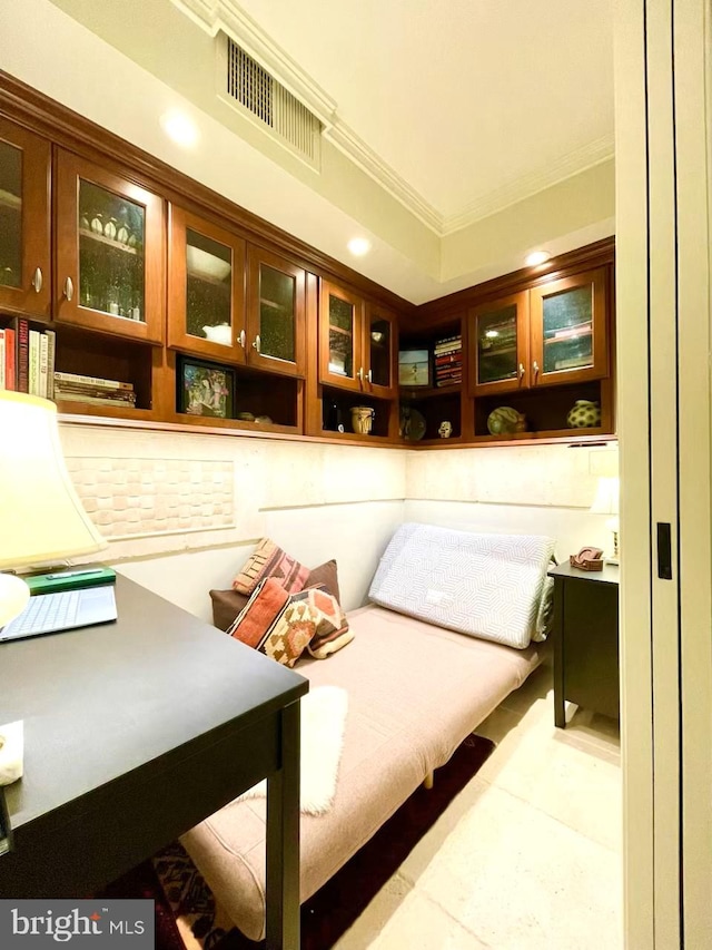 sitting room featuring light tile patterned floors and crown molding