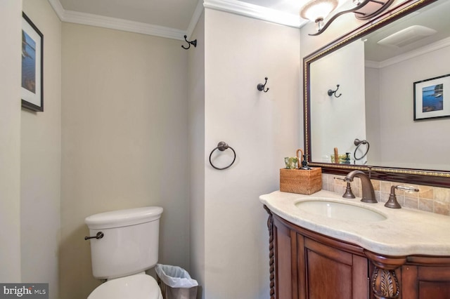 bathroom featuring crown molding, vanity, and toilet