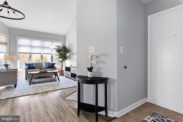 interior space with hardwood / wood-style floors and lofted ceiling