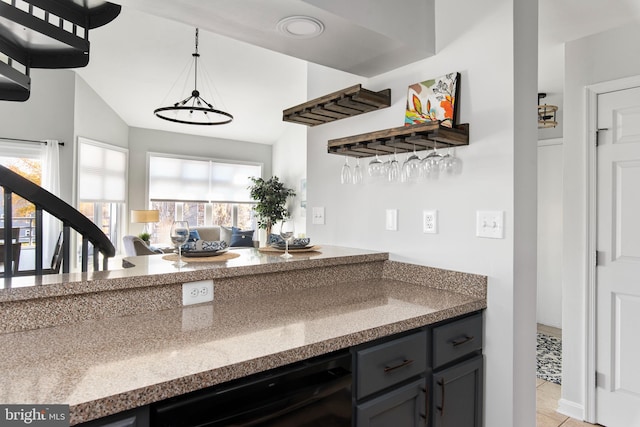 kitchen with light tile patterned floors, hanging light fixtures, wine cooler, and vaulted ceiling