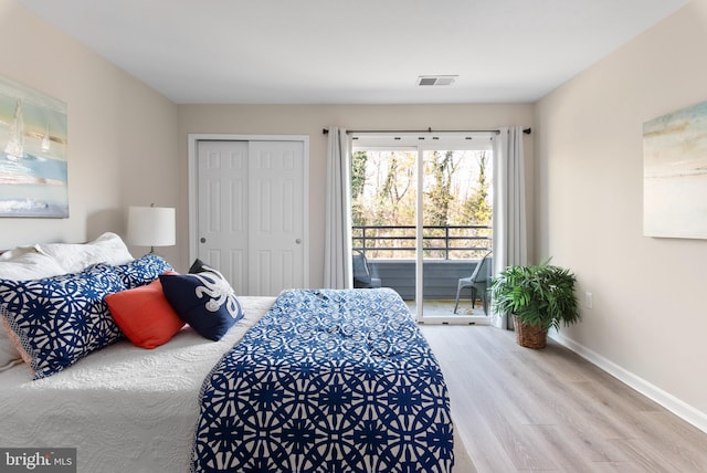 bedroom featuring hardwood / wood-style flooring, access to outside, and a closet