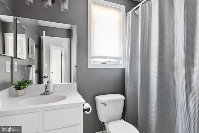 bathroom featuring vanity and toilet