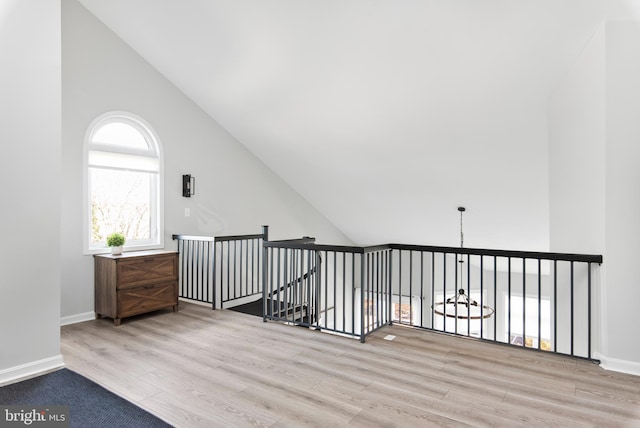 bonus room featuring high vaulted ceiling and light hardwood / wood-style flooring