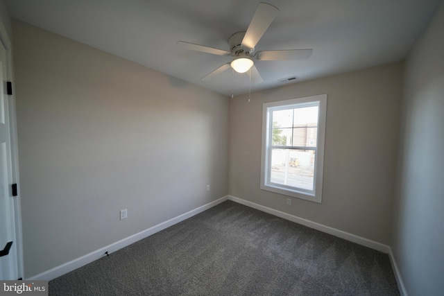 carpeted spare room featuring ceiling fan