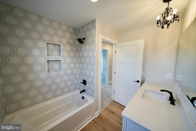 bathroom featuring bathtub / shower combination, vanity, hardwood / wood-style flooring, and a notable chandelier