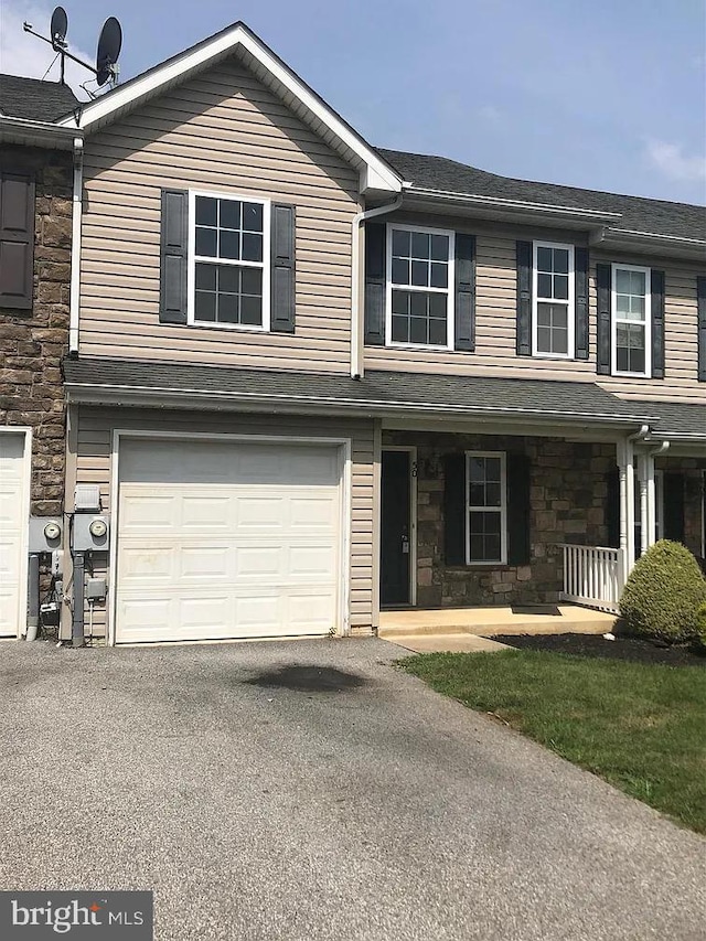 view of front of house featuring a porch and a garage