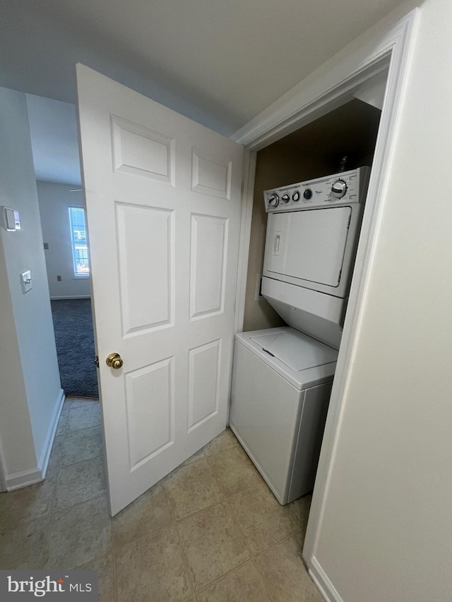 laundry area with stacked washer / drying machine